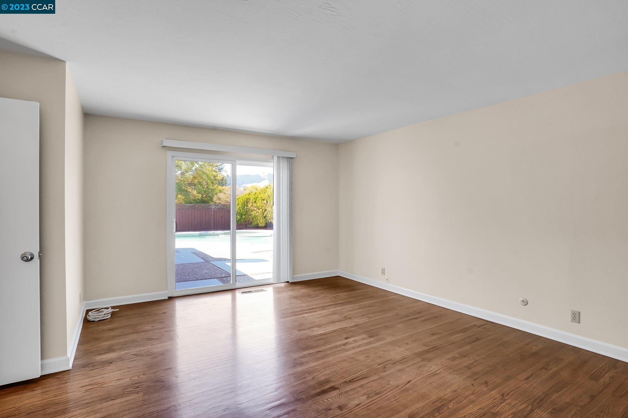 348 Barrett Circle Danville, CA 94526 - Photo 24 of 41 a view of an empty room with wooden floor and a window