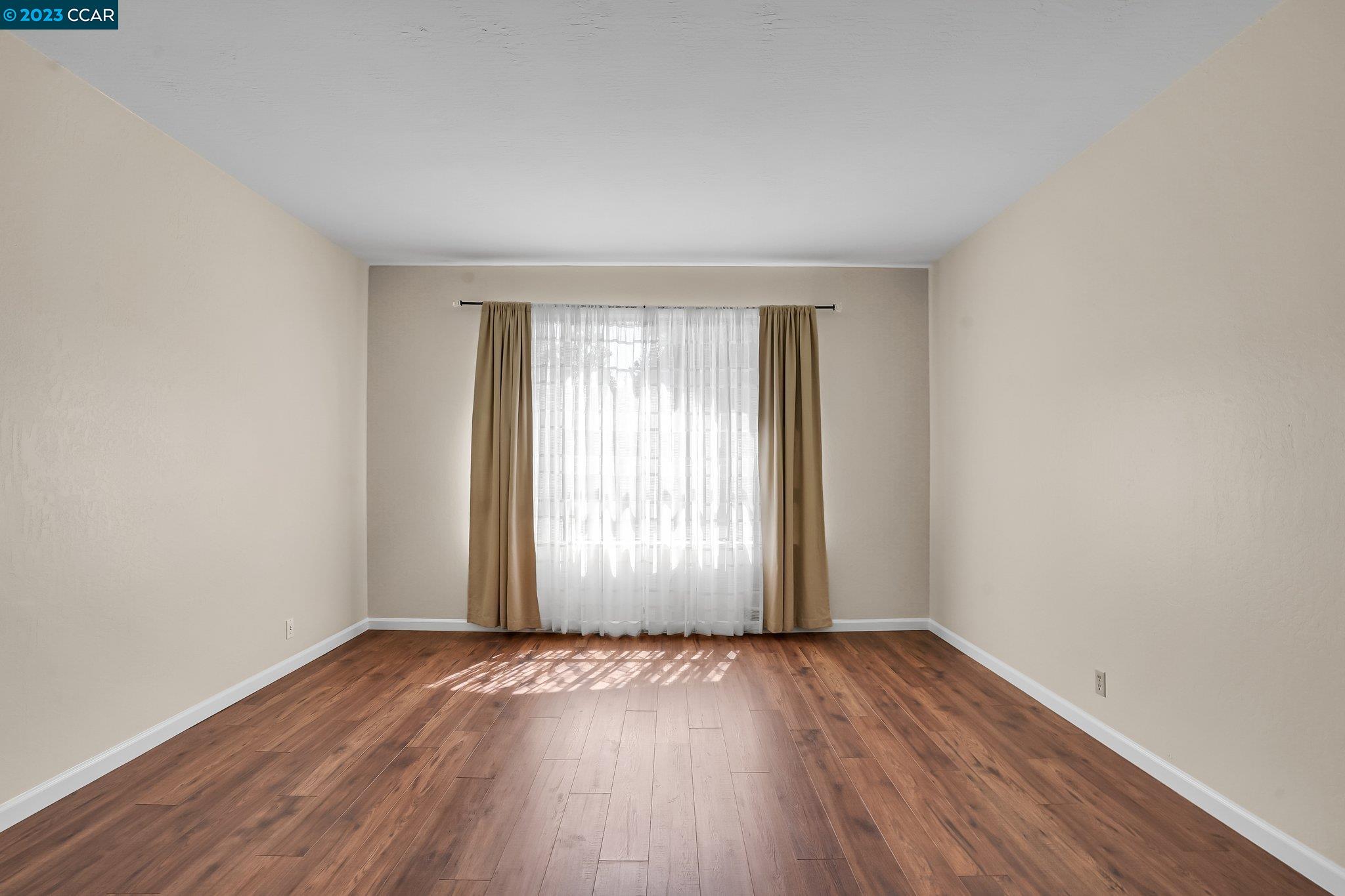 348 Barrett Circle Danville, CA 94526 - Photo 9 of 41 an empty room with wooden floor and windows