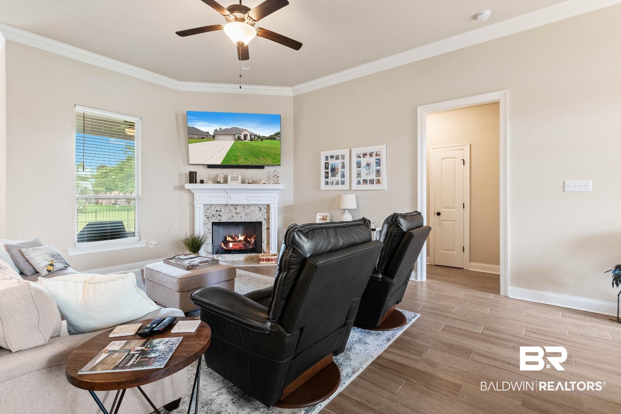22244 Hibiscus Circle Foley, AL 36535 - Photo 13 of 51 Living area featuring a corner fireplace with a white mantel and stone surround