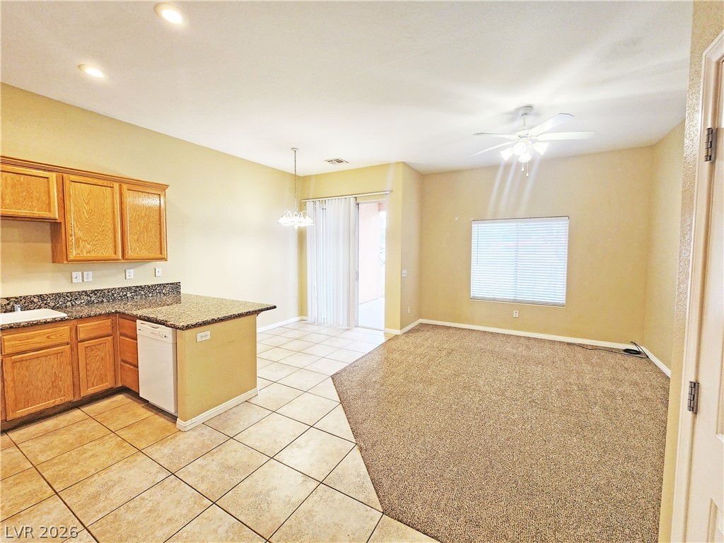 1421 Star Road, Unit 2 Pahrump, NV 89048 - Photo 5 of 33 Kitchen with a sink, dishwasher, a ceiling fan, a peninsula, and light tile patterned floors