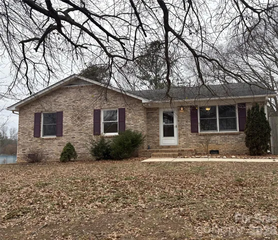 a house that has a tree in front of it