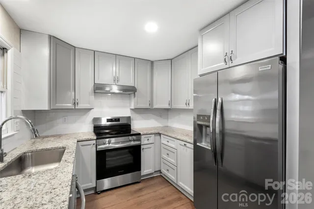a kitchen with a refrigerator stove and sink