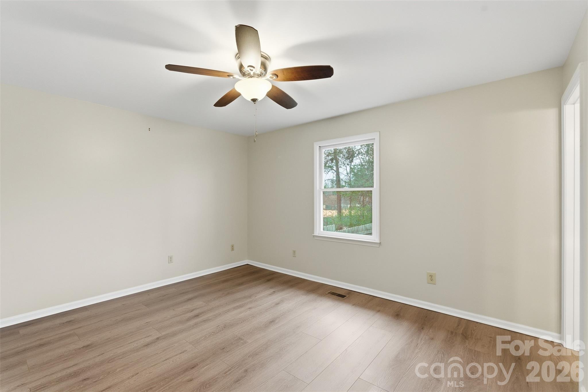 225 Belhaven Circle Clover, SC 29710 - Photo 17 of 29 an empty room with wooden floor fan and windows