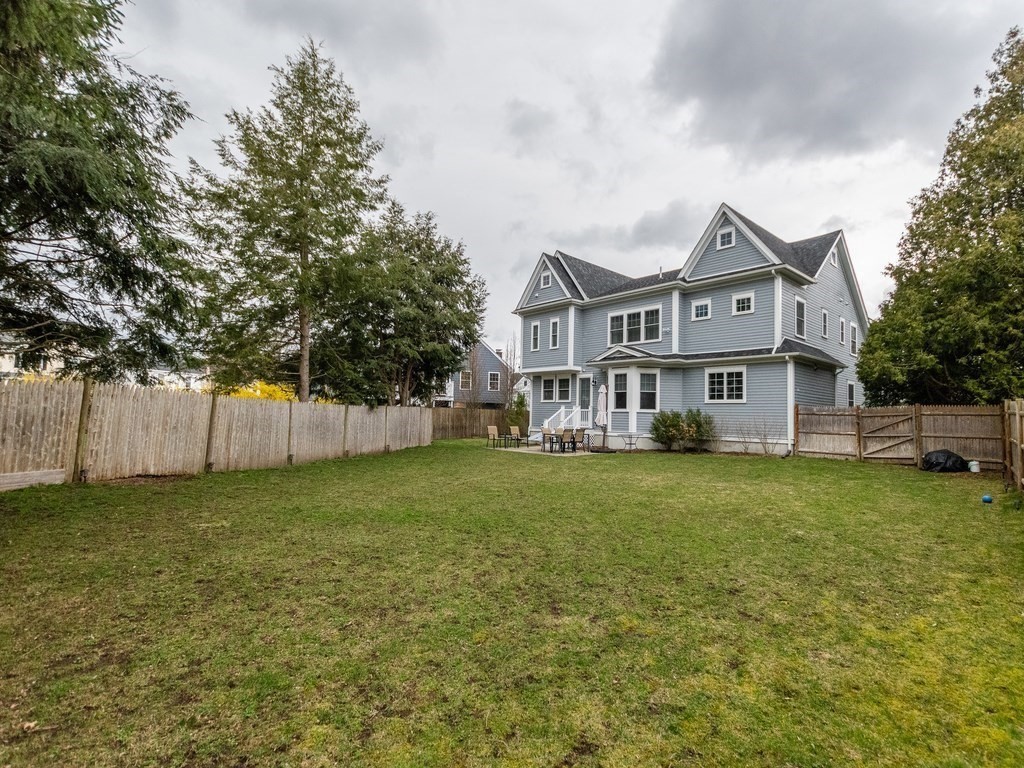1708 Great Plain Avenue Needham, MA 02492 - Photo 2 of 34 a front view of a house with a garden