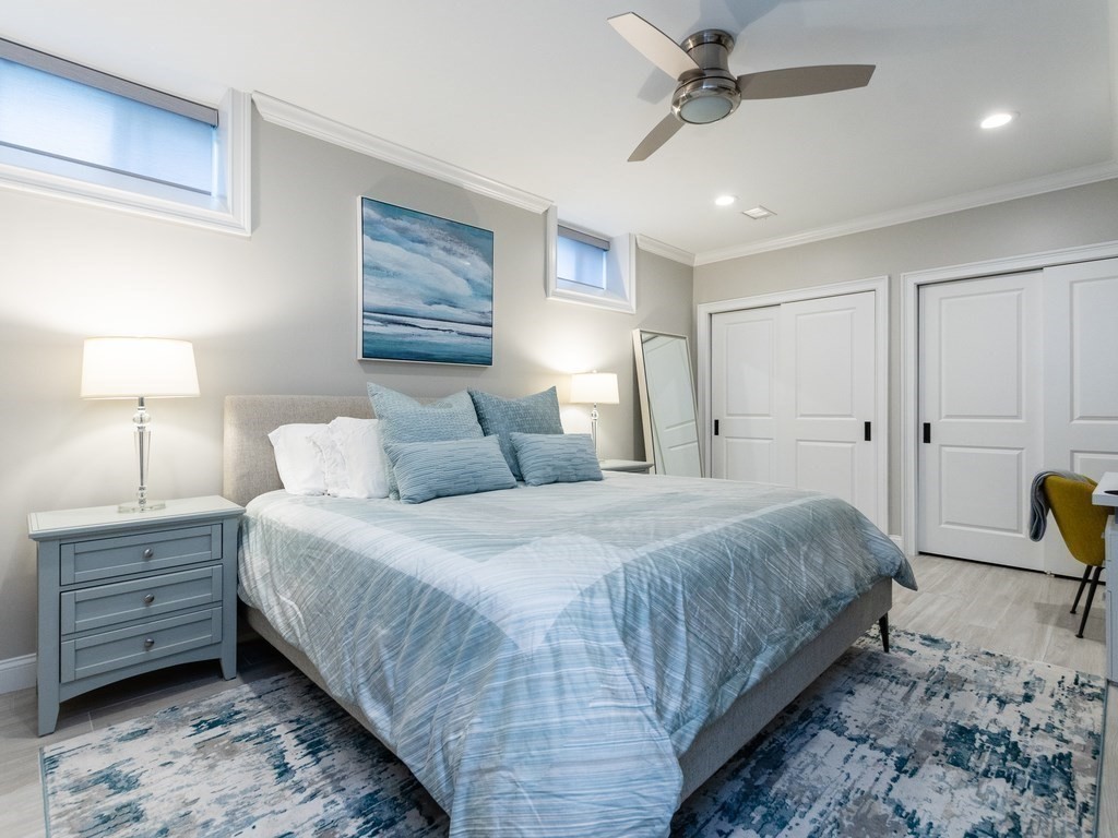 1708 Great Plain Avenue Needham, MA 02492 - Photo 25 of 34 a bedroom with a bed a dresser and a lamp