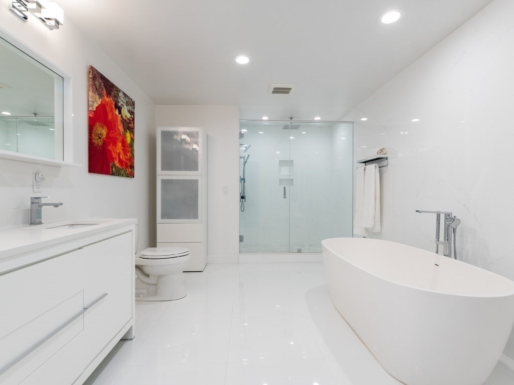 1708 Great Plain Avenue Needham, MA 02492 - Photo 26 of 34 a bathroom with a sink a toilet and a large mirror