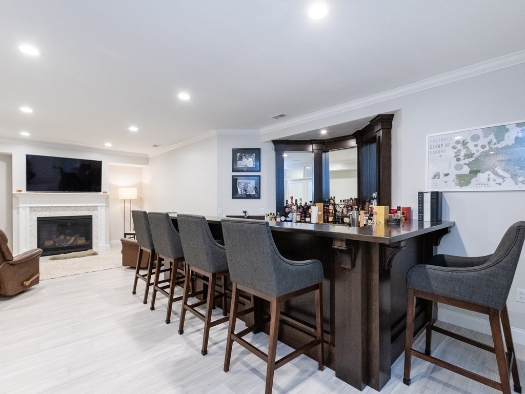 1708 Great Plain Avenue Needham, MA 02492 - Photo 28 of 34 a view of a dining room with furniture and a fireplace