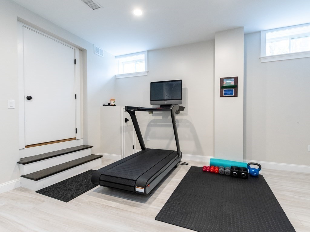 1708 Great Plain Avenue Needham, MA 02492 - Photo 29 of 34 a living room with furniture and a flat screen tv
