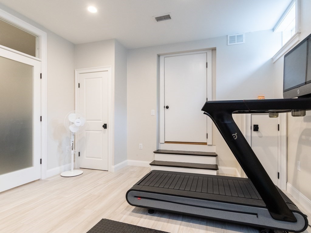 1708 Great Plain Avenue Needham, MA 02492 - Photo 30 of 34 a view of a hallway with wooden floor and staircase