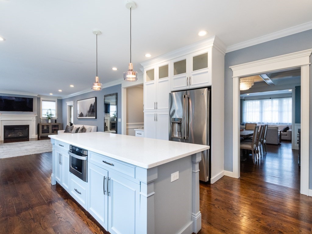 1708 Great Plain Avenue Needham, MA 02492 - Photo 8 of 34 a large kitchen with stainless steel appliances kitchen island a large counter top and a wooden floors