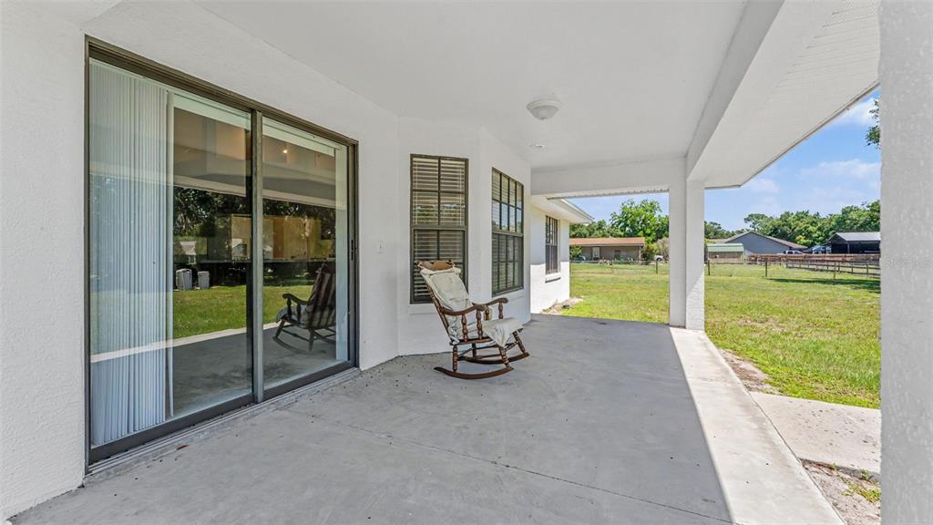 8525 North Campbell Road Lakeland, FL 33810 - Photo 9 of 45 a view of a room with porch and wooden floor