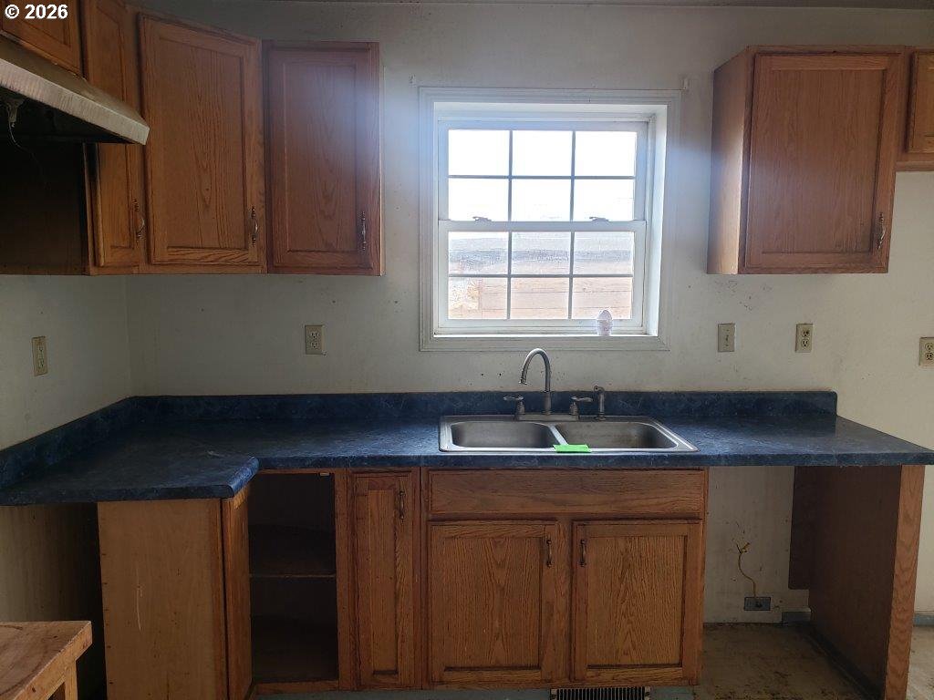 907 South College Street Joseph, OR 97846 - Photo 22 of 25 a kitchen with stainless steel appliances granite countertop wooden cabinets a sink and dishwasher