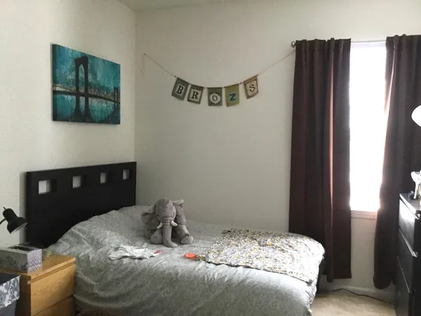 a bedroom with a bed and a wall painting