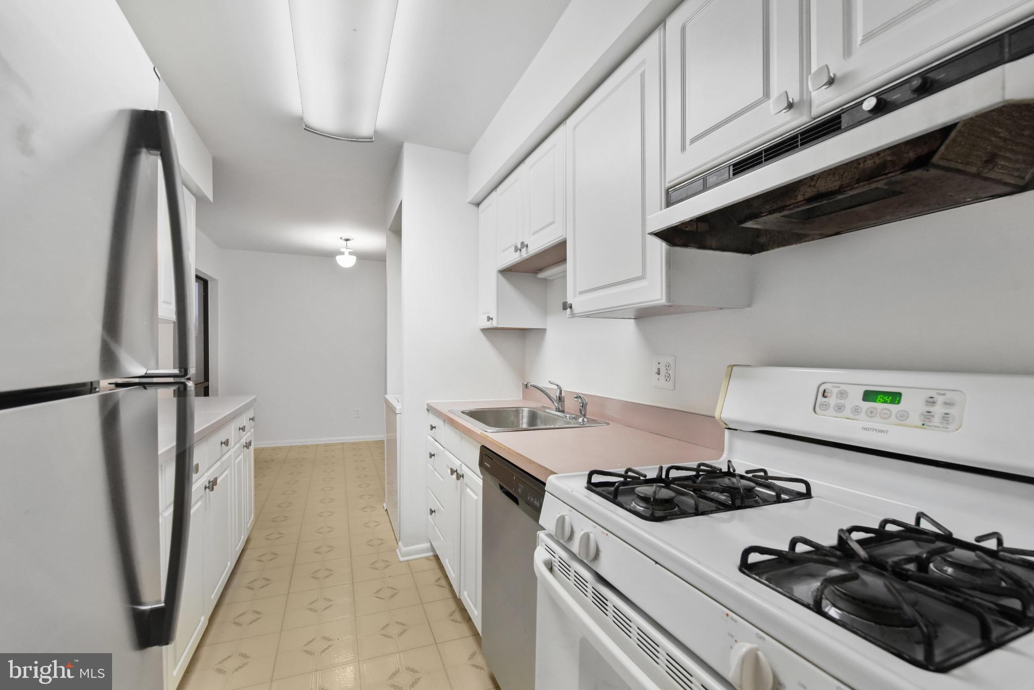 11212 Chestnut Grove Square, Unit 313 Reston, VA 20190 - Photo 8 of 22 a kitchen with stainless steel appliances a sink a stove and a refrigerator