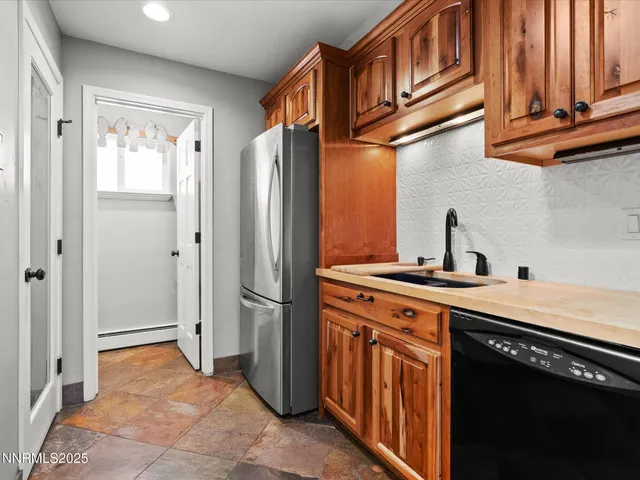 a kitchen with granite countertop a sink and a stove top oven