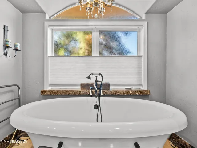 a spacious bathroom with a granite countertop sink toilet mirror and shower