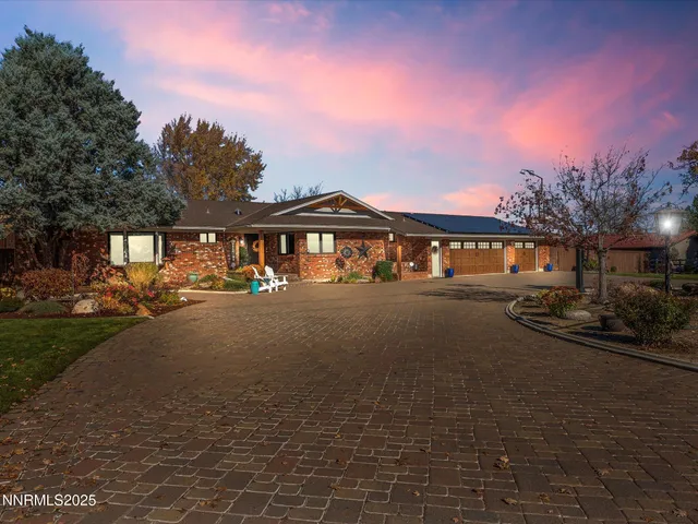 a living room with furniture a dining table and a fireplace