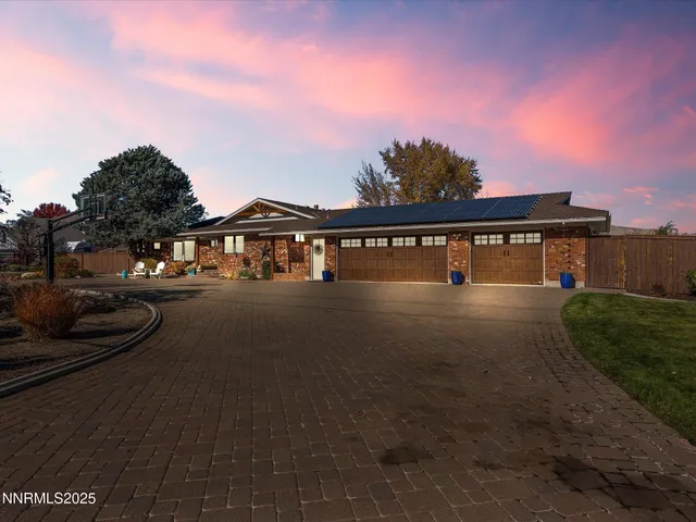 a large kitchen with stainless steel appliances granite countertop a lot of counter space and a sink