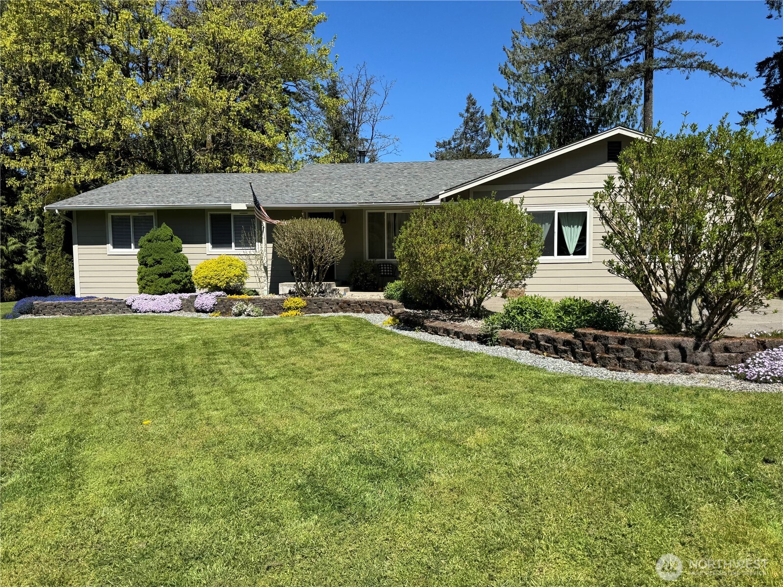 a front view of a house with a yard and trees