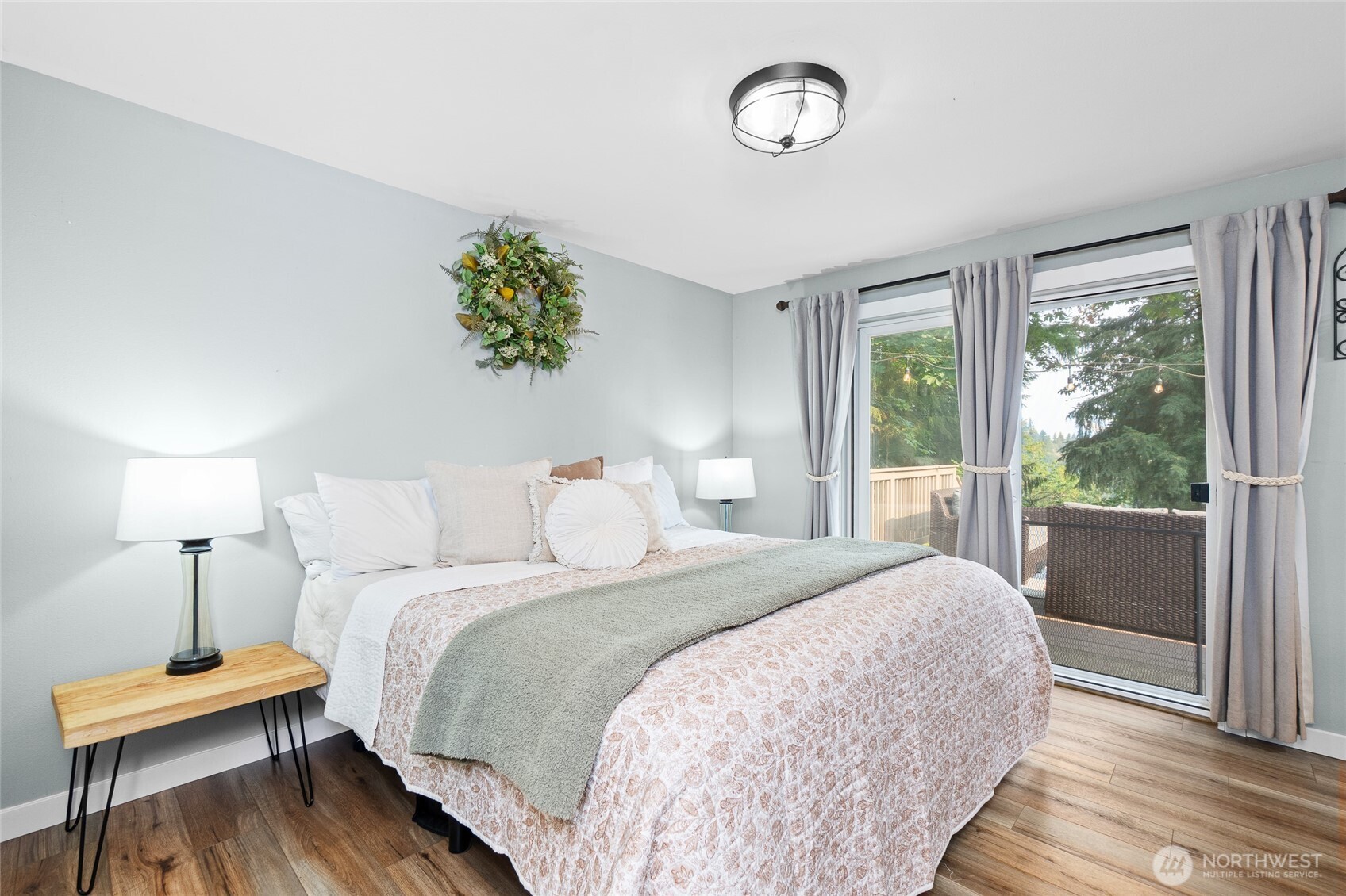 16115 243rd Street East Graham, WA 98338 - Photo 11 of 38 a bedroom with a bed and a lamp