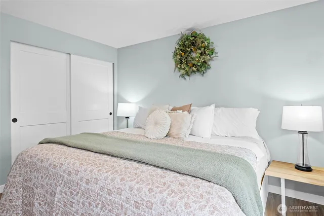 a bedroom with a bed and a lamp