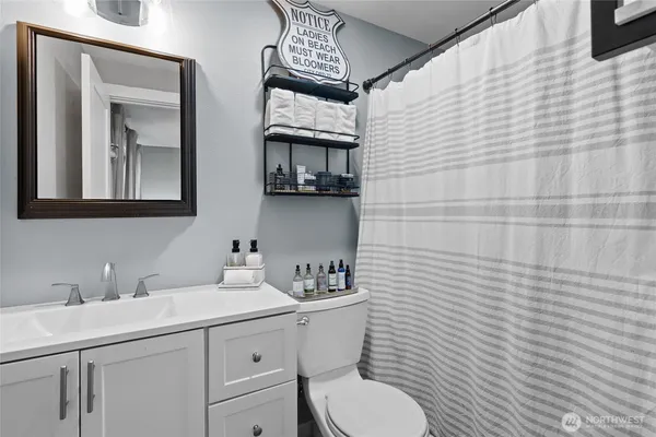 a bathroom with a toilet sink and mirror