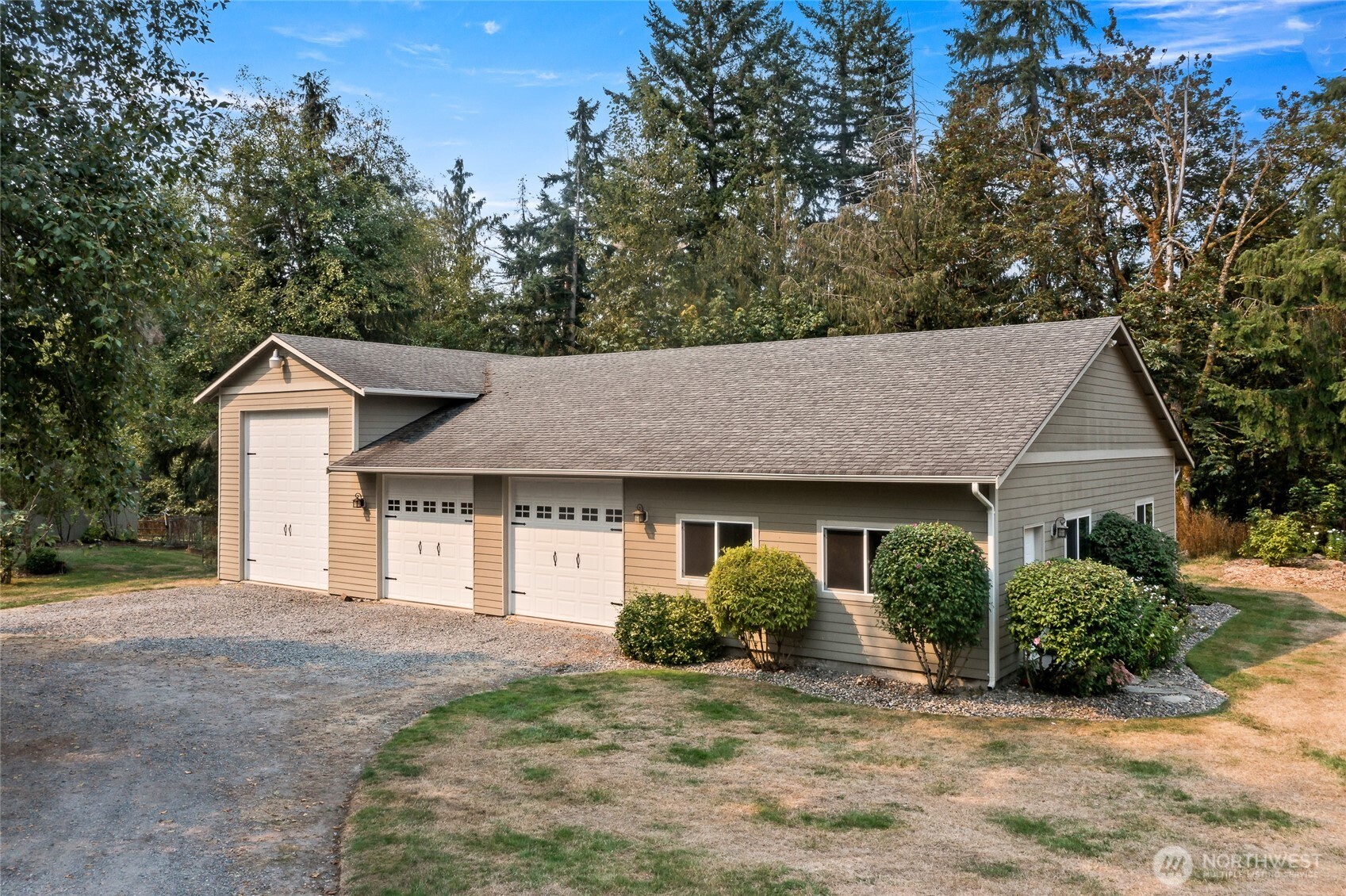 16115 243rd Street East Graham, WA 98338 - Photo 19 of 38 a front view of a house with a yard and garage