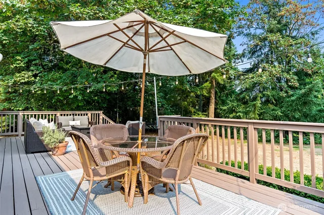 a view of balcony with furniture and umbrella