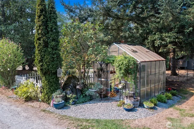 a backyard of a house with table and chairs