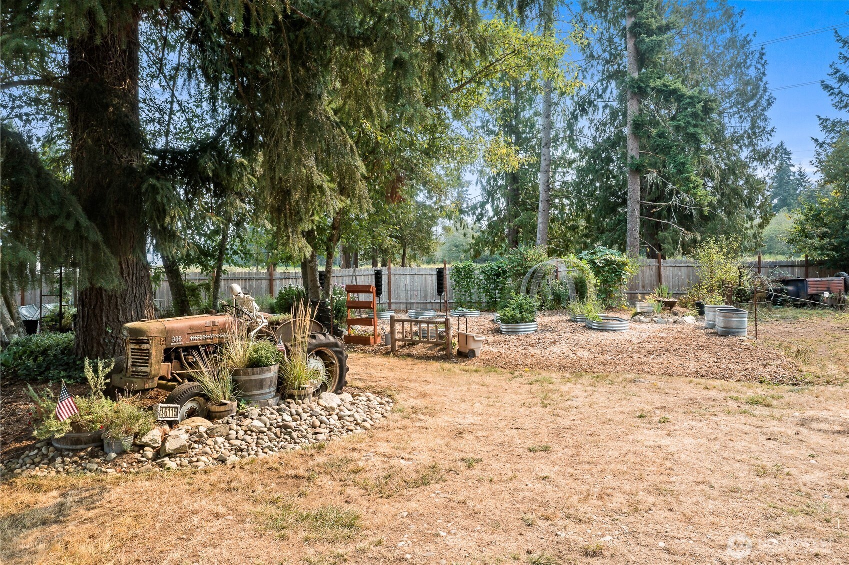 16115 243rd Street East Graham, WA 98338 - Photo 33 of 38 a view of a wooden bench sitting in the backyard