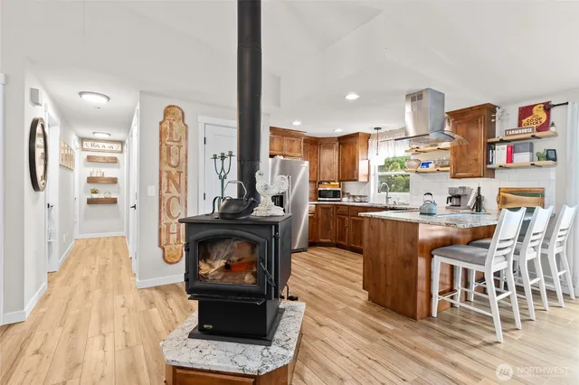 a kitchen with stainless steel appliances granite countertop a refrigerator and a stove top oven