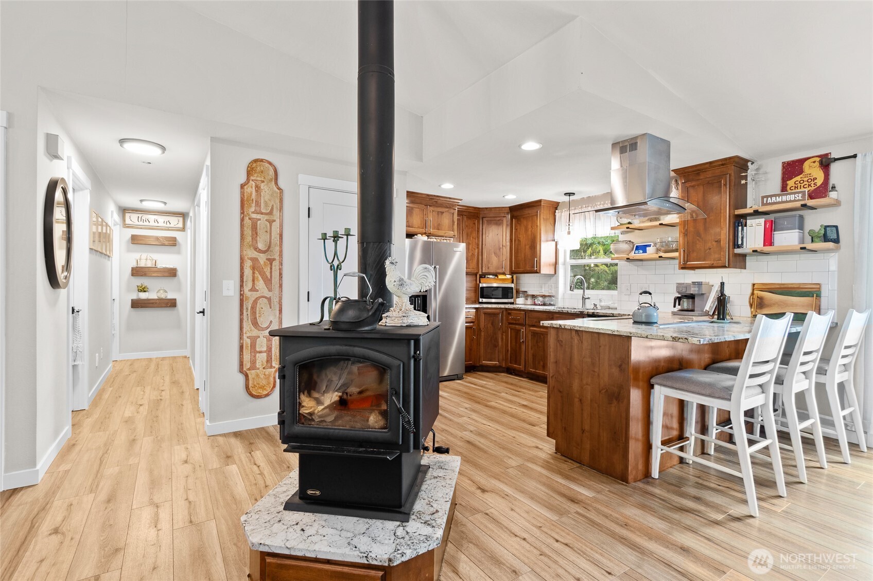 16115 243rd Street East Graham, WA 98338 - Photo 4 of 38 a kitchen with stainless steel appliances granite countertop a refrigerator and a stove top oven