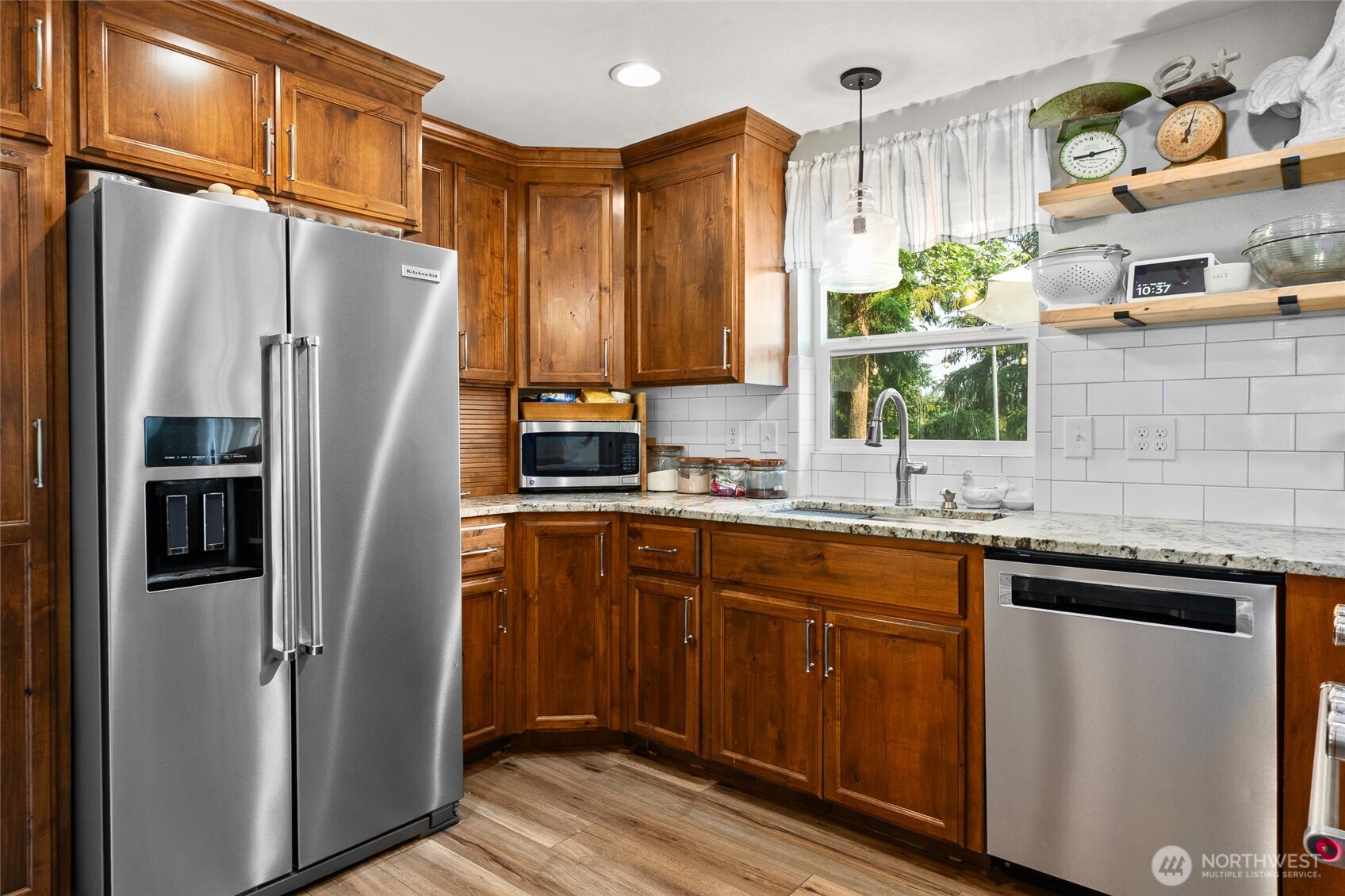 16115 243rd Street East Graham, WA 98338 - Photo 6 of 38 a kitchen with stainless steel appliances granite countertop a refrigerator and a sink