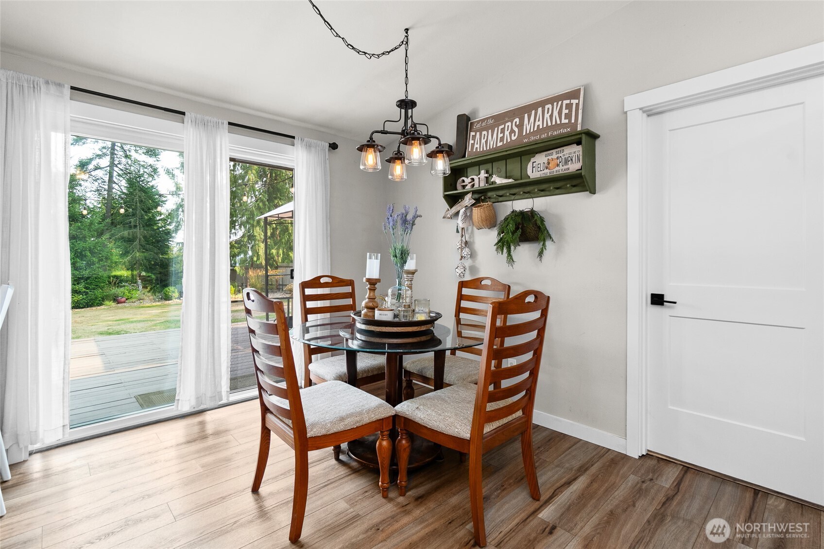 16115 243rd Street East Graham, WA 98338 - Photo 7 of 38 a dining room with furniture a chandelier and wooden floor