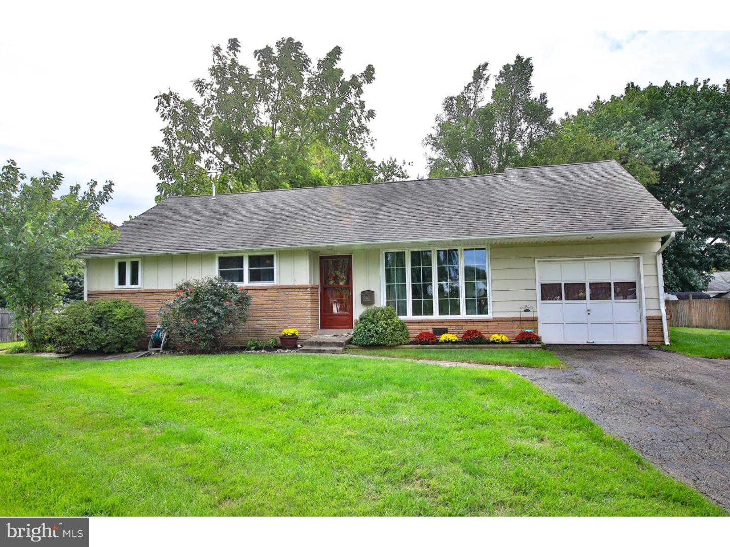 754 Spruce Road Warminster, PA 18974 - Photo 1 of 25 a front view of a house with a garden and trees