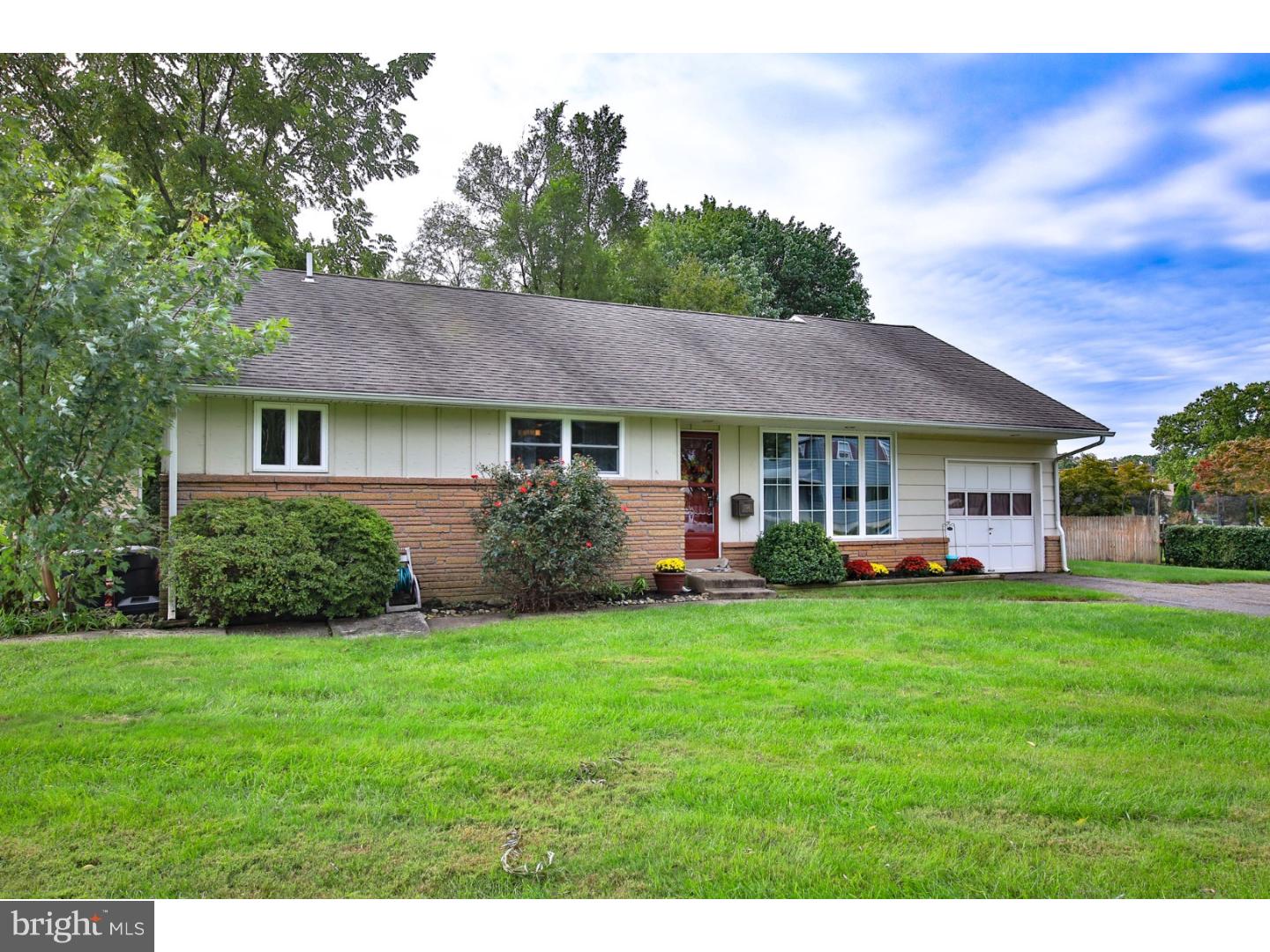 754 Spruce Road Warminster, PA 18974 - Photo 2 of 25 a front view of a house with a garden and trees