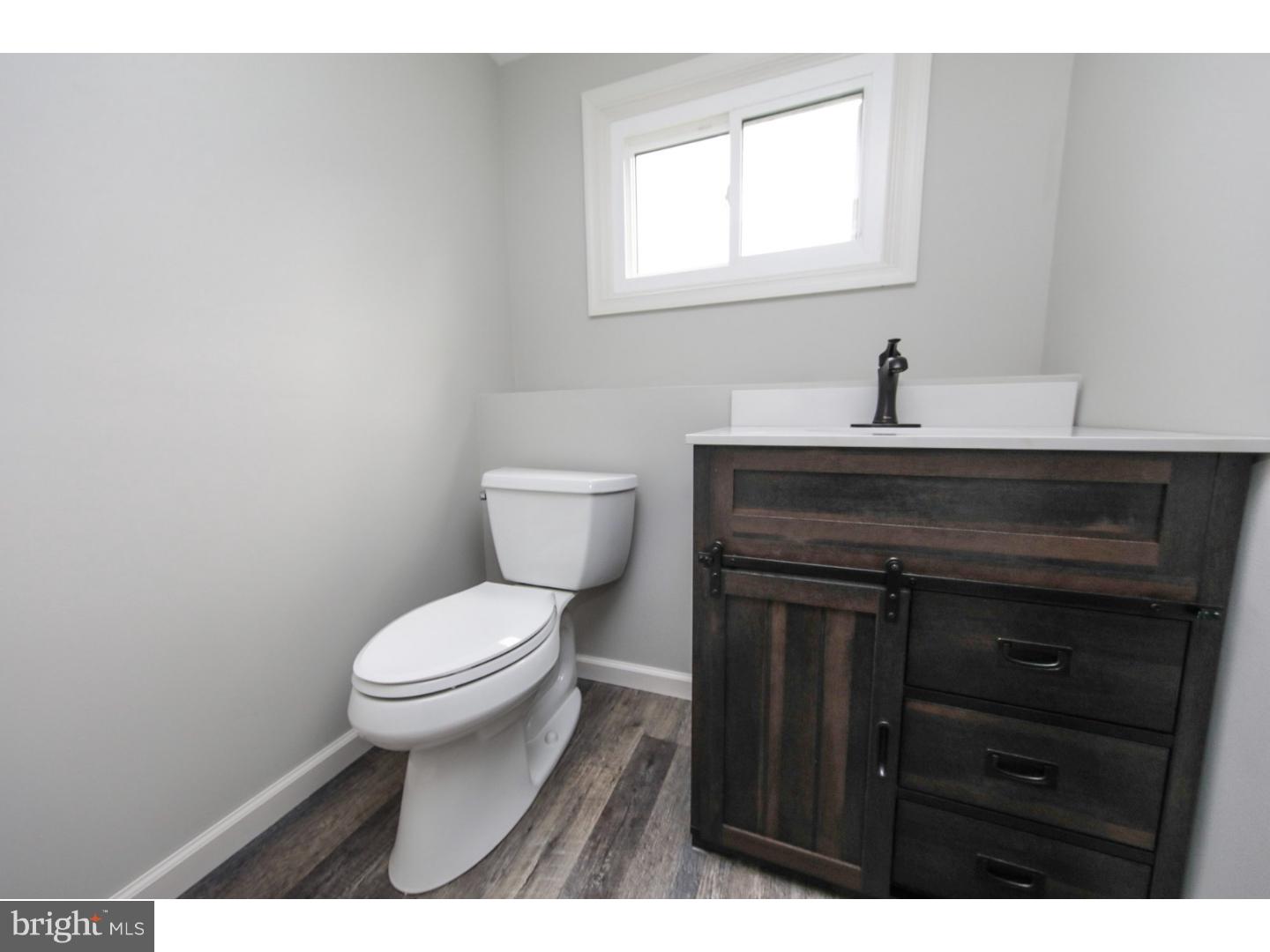 754 Spruce Road Warminster, PA 18974 - Photo 14 of 25 a bathroom with a toilet a sink and mirror