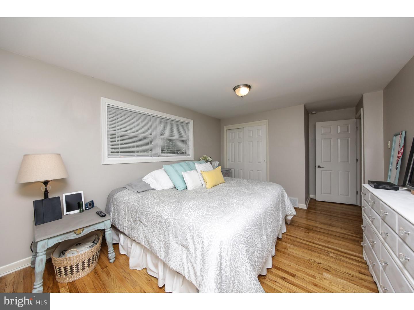 754 Spruce Road Warminster, PA 18974 - Photo 16 of 25 a bedroom with a bed and a lamp on dresser