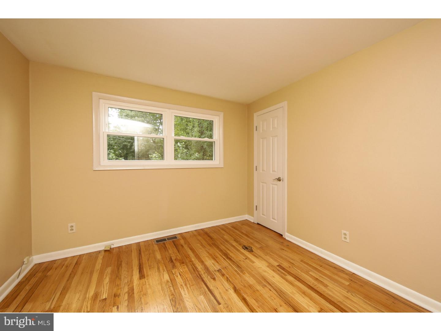 754 Spruce Road Warminster, PA 18974 - Photo 20 of 25 a view of an empty room with wooden floor and a window
