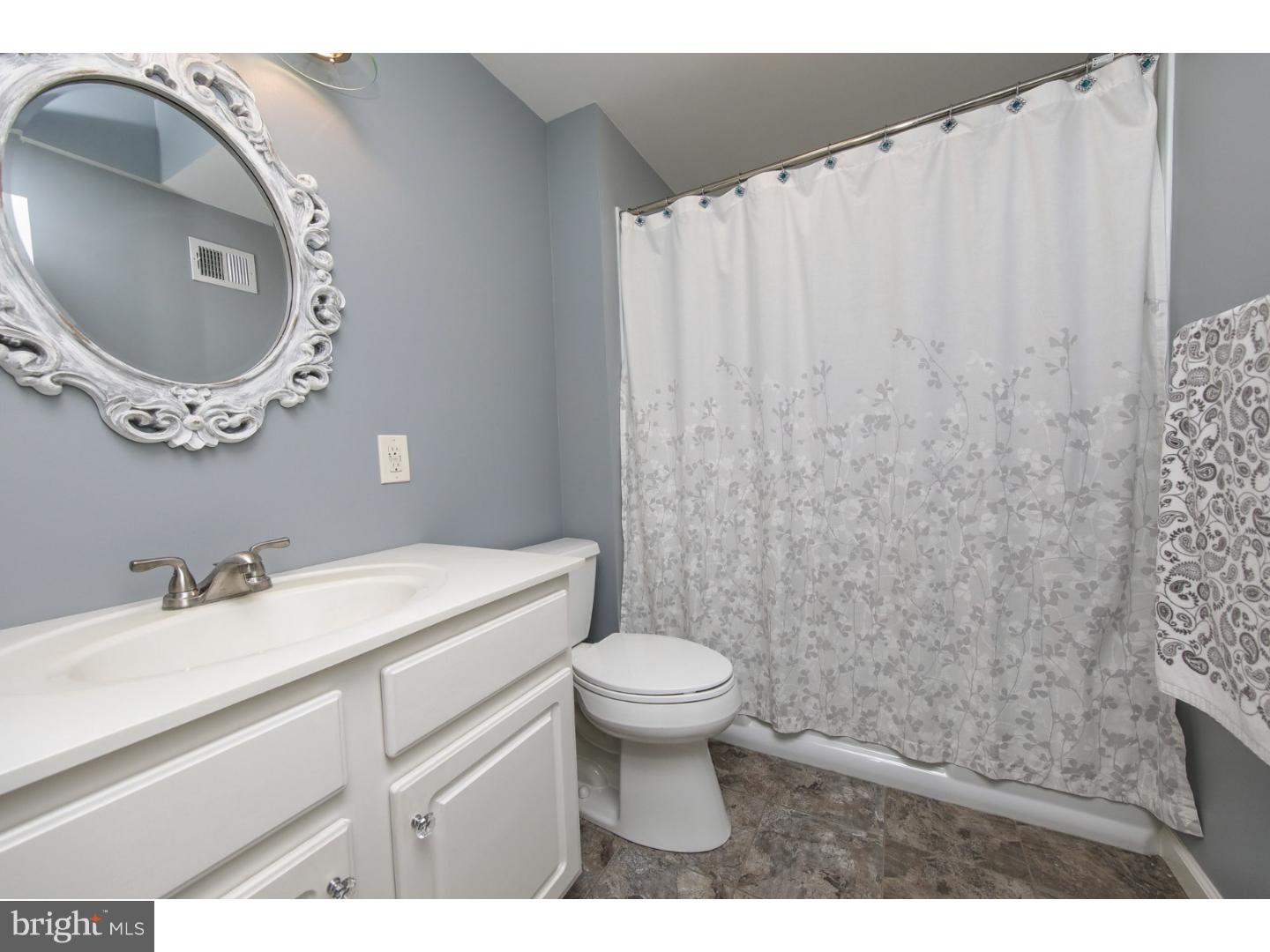 754 Spruce Road Warminster, PA 18974 - Photo 22 of 25 a bathroom with a toilet sink vanity and mirror