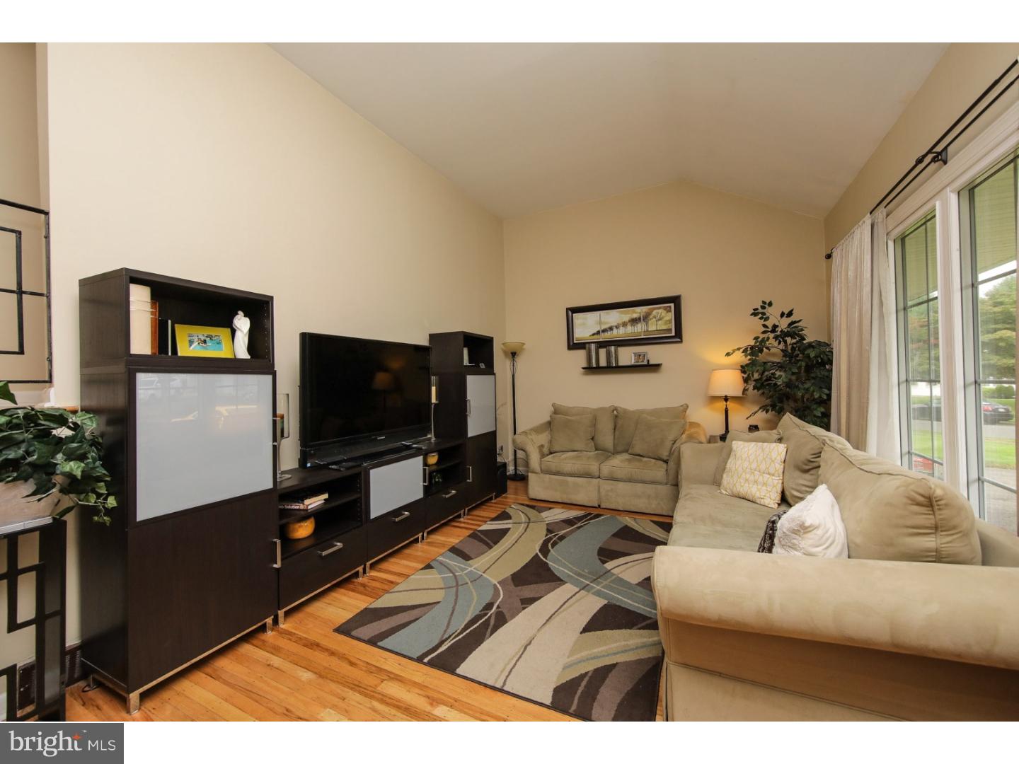754 Spruce Road Warminster, PA 18974 - Photo 4 of 25 a living room with furniture and a flat screen tv