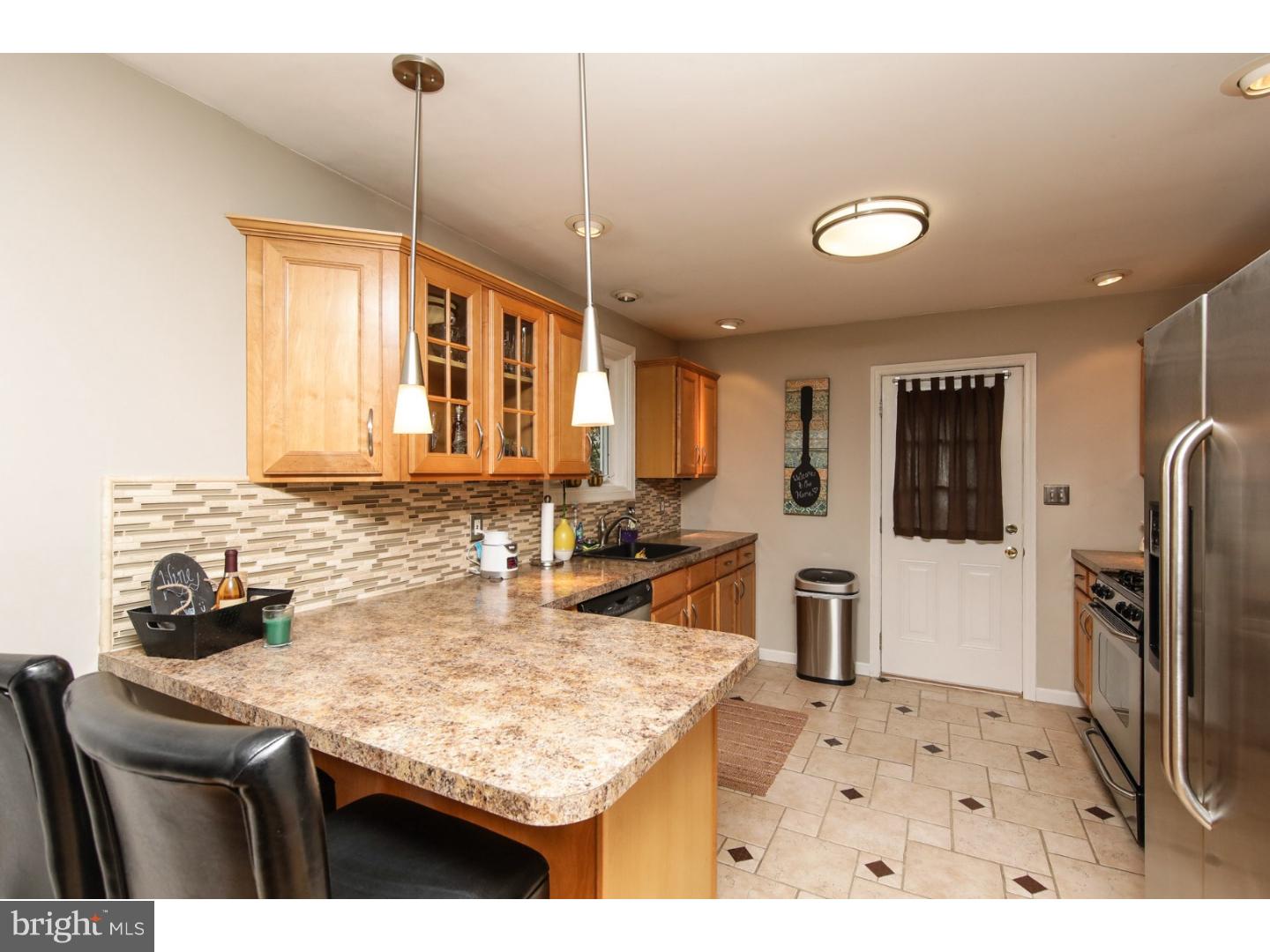 754 Spruce Road Warminster, PA 18974 - Photo 7 of 25 a kitchen with stainless steel appliances granite countertop a sink refrigerator and cabinets