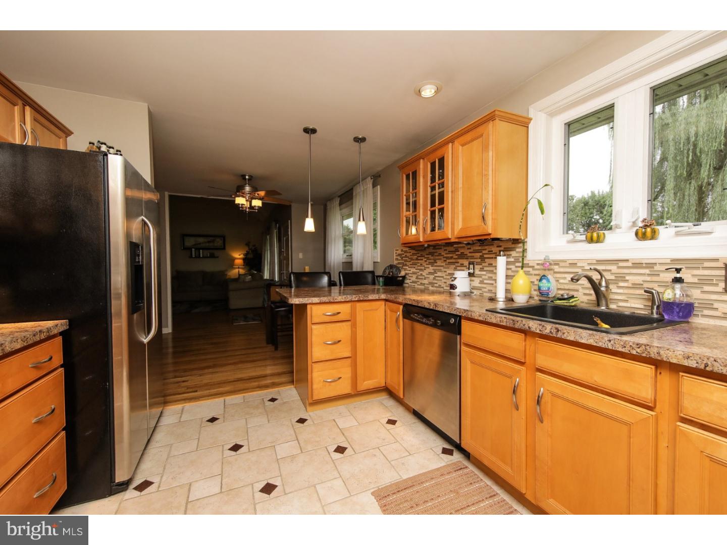 754 Spruce Road Warminster, PA 18974 - Photo 8 of 25 a large kitchen with stainless steel appliances kitchen island granite countertop a refrigerator and cabinets