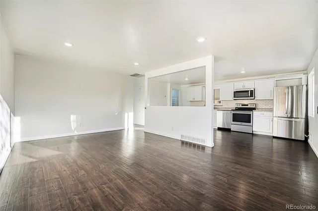 a view of a kitchen with a sink and a stove top oven
