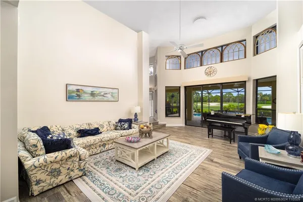 a living room with furniture and large windows