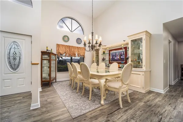 a dining room with furniture a rug and wooden floor