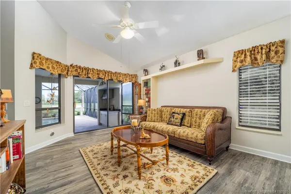 a living room with furniture and wooden floor