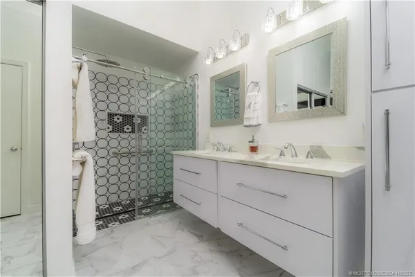 a bathroom with a shower sink and mirror