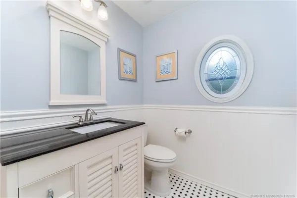 a bathroom with a toilet a sink and mirror
