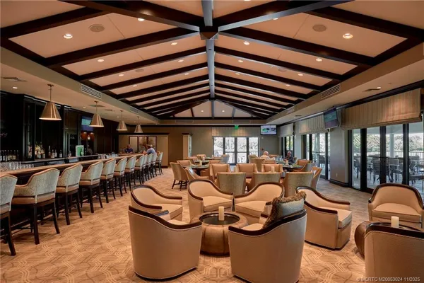 a living room with lots of furniture and a large window